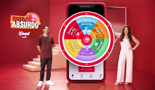 Promoção "Novembro Absurdo" do iFood com uma roleta de prêmios em destaque, acompanhada por duas pessoas sorridentes.