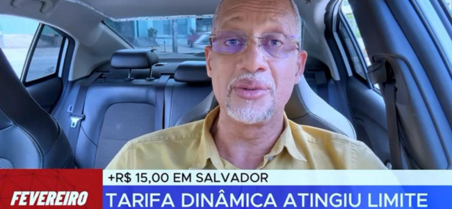 Motorista de aplicativo, Cláudio Sena, grava vídeo dentro de seu carro, comentando sobre a tarifa dinâmica em Salvador.