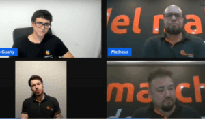 Quatro homens participam de uma videoconferência. Dois usam camisetas com o logo da Golmatch, e um usa camiseta da Goahy. Todos estão em ambientes internos, cada um em seu respectivo quadro na tela.