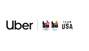 Logo da Uber ao lado dos logotipos dos Jogos Olímpicos e Paralímpicos de Los Angeles 2028 e da equipe olímpica dos Estados Unidos (Team USA).