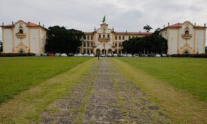 Fachada principal da Universidade Federal Rural do Rio de Janeiro com gramado e caminho de pedra ao centro