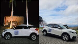 Carro branco modelo SUV com adesivo da "Magda Oliver Produções" estacionado em dois locais diferentes: à noite em frente a um castelo iluminado e durante o dia com paisagem montanhosa ao fundo.
