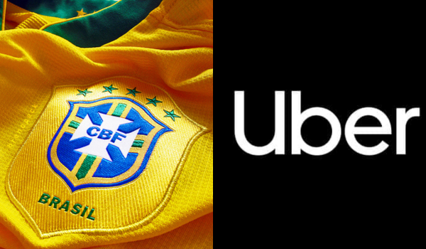 Detalhe da camisa amarela da seleção brasileira com o escudo da CBF ao lado do logotipo branco da Uber sobre fundo preto.