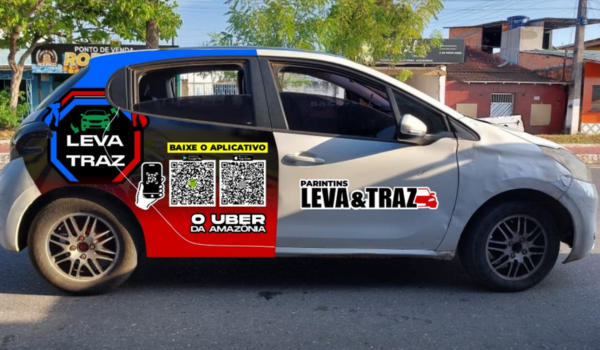 Carro branco estacionado com adesivagem promocional do serviço Leva & Traz, incluindo QR code, textos e elementos gráficos nas laterais.